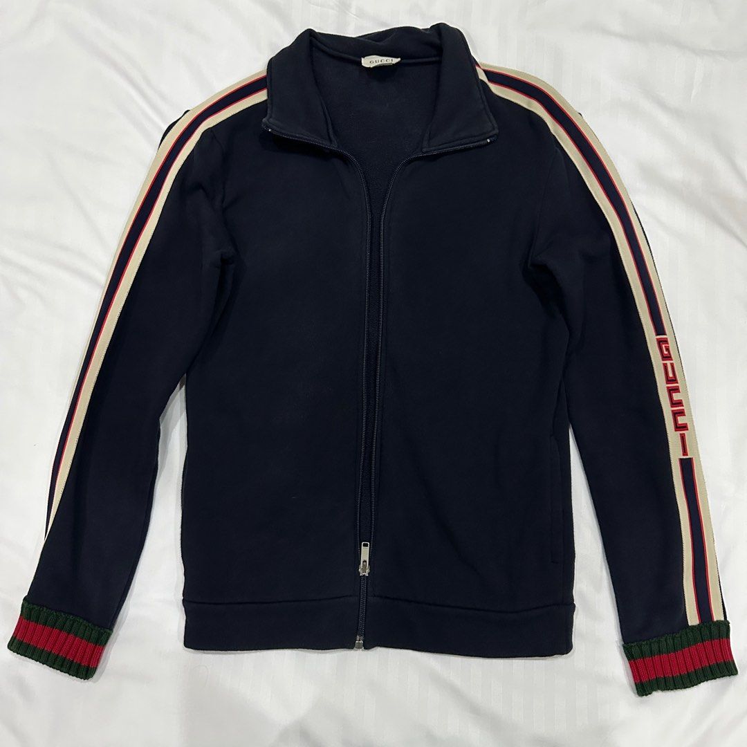 Gucci Jacquard Track Suit (Category: Coats, Jackets and Outerwear) located in Quezon City. Submitted by ishdeclutters (Listing ID 1288361678, Image 3). Description: Condition: 9/10 Color: Navy Blue, Red-Green Stripes Size: XS-S Womens / Teens 12 Material: Organic Cotton Long Sleeves, Ribbed Cuffs, Logo print at shoulder, signature web stripe trim Brand Style ID: 497307X9L52.