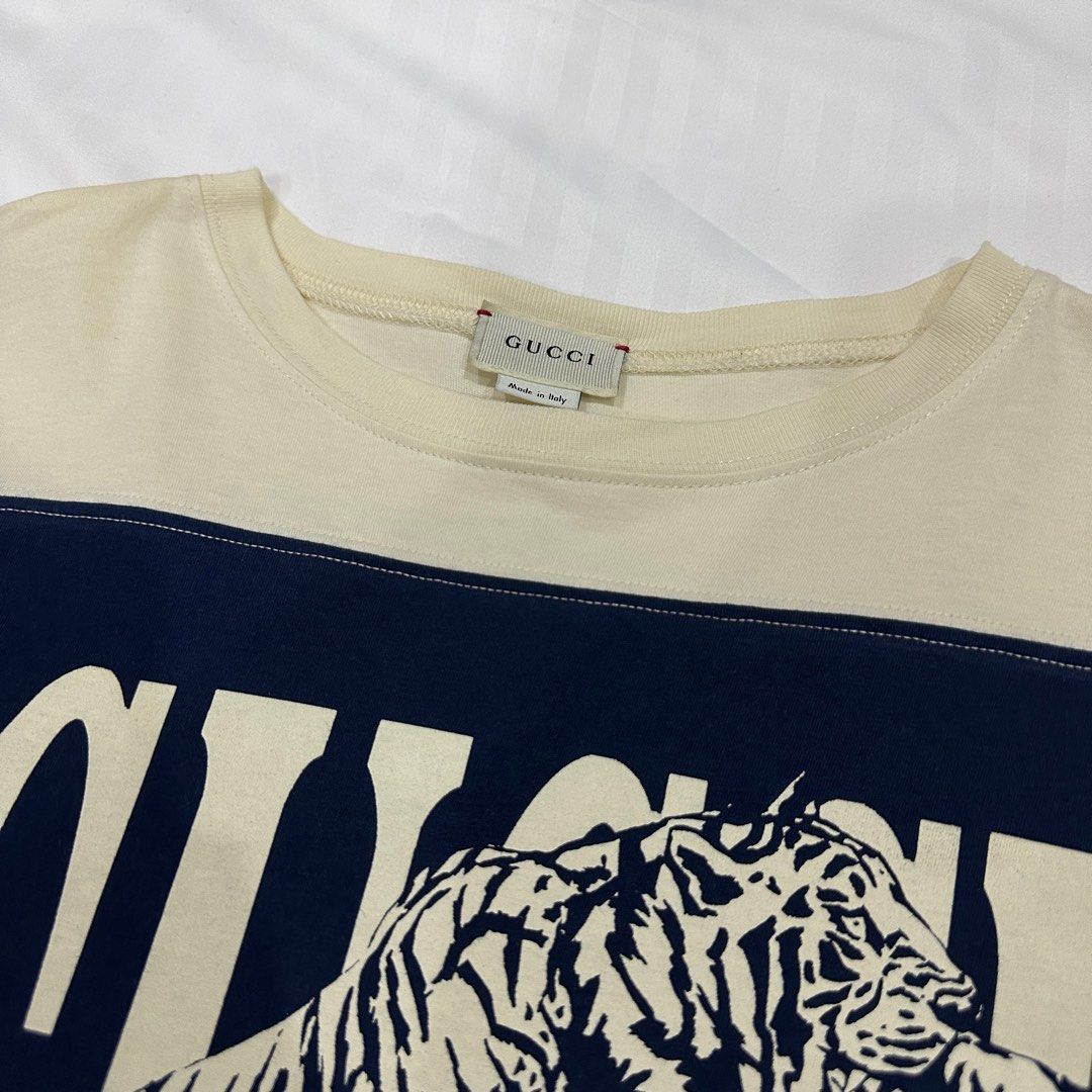 Gucci Tiger Print Shirt (Category: Shirts) located in Quezon City. Submitted by ishdeclutters (Listing ID 1288359970, Image 3). Description: Condition: 9.8/10 Color: Navy Blue, Off White with Tiger Print Size: S-M Womens / Teens 14 Material: 100% Cotton Jersey Made in Italy Brand Style ID: 568860XJBC3.