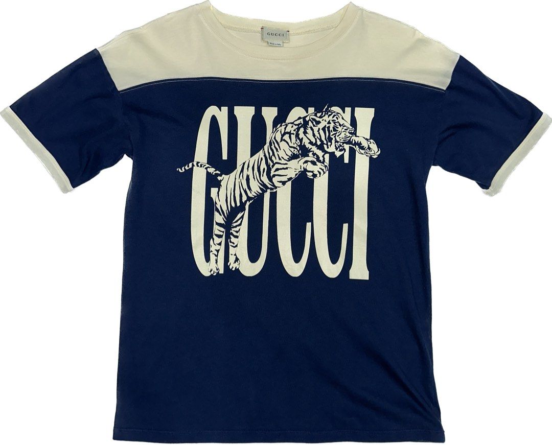 Gucci Tiger Print Shirt (Category: Shirts) located in Quezon City. Submitted by ishdeclutters (Listing ID 1288359970, Image 1). Description: Condition: 9.8/10 Color: Navy Blue, Off White with Tiger Print Size: S-M Womens / Teens 14 Material: 100% Cotton Jersey Made in Italy Brand Style ID: 568860XJBC3.