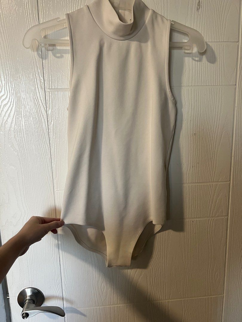 White turtle neck body suit (Category: Sleeveless) located in Quezon City. Submitted by pgv18 (Listing ID 1288363520, Image 1). Description: Fits XS-S Nice stretchy material Bought in Australia Any discoloration is only due to photo’s lighting .