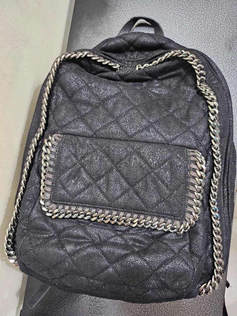 Stella McCartney Quilted Black backpack (Category: Luxury Bags & Wallets) located in Quezon City. Submitted by turtle_85 (Listing ID 1288665566, Image 1). Description: Quilted material with silver metal embellishment. Front pocket. Also has large pocket inside. There are scratches and scuffs on the body. There are small scratches and peeling on the hardware, but it is a relatively clean item..