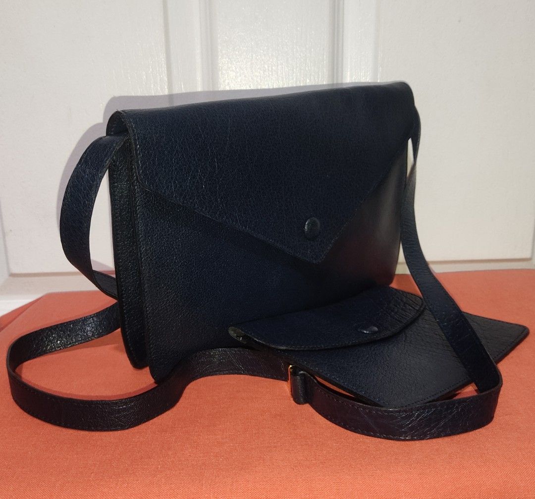 Preloved FRANCOIS VILLON Paris (Category: Cross-body Bags) located in Pasig City. Submitted by bcthriftedzoneonlineshop (Listing ID 1289324247, Image 2). Description: * Cowhide leather material * In- mid night blue color * Gold hardware * Adjustable and removable strap available * Envelope Type Sling Bag * Can be used as a clutch bag * Suede leather lining with 1 open pocket inside the bag * Comes with a leather pouch * Signs of usage bag ( strap