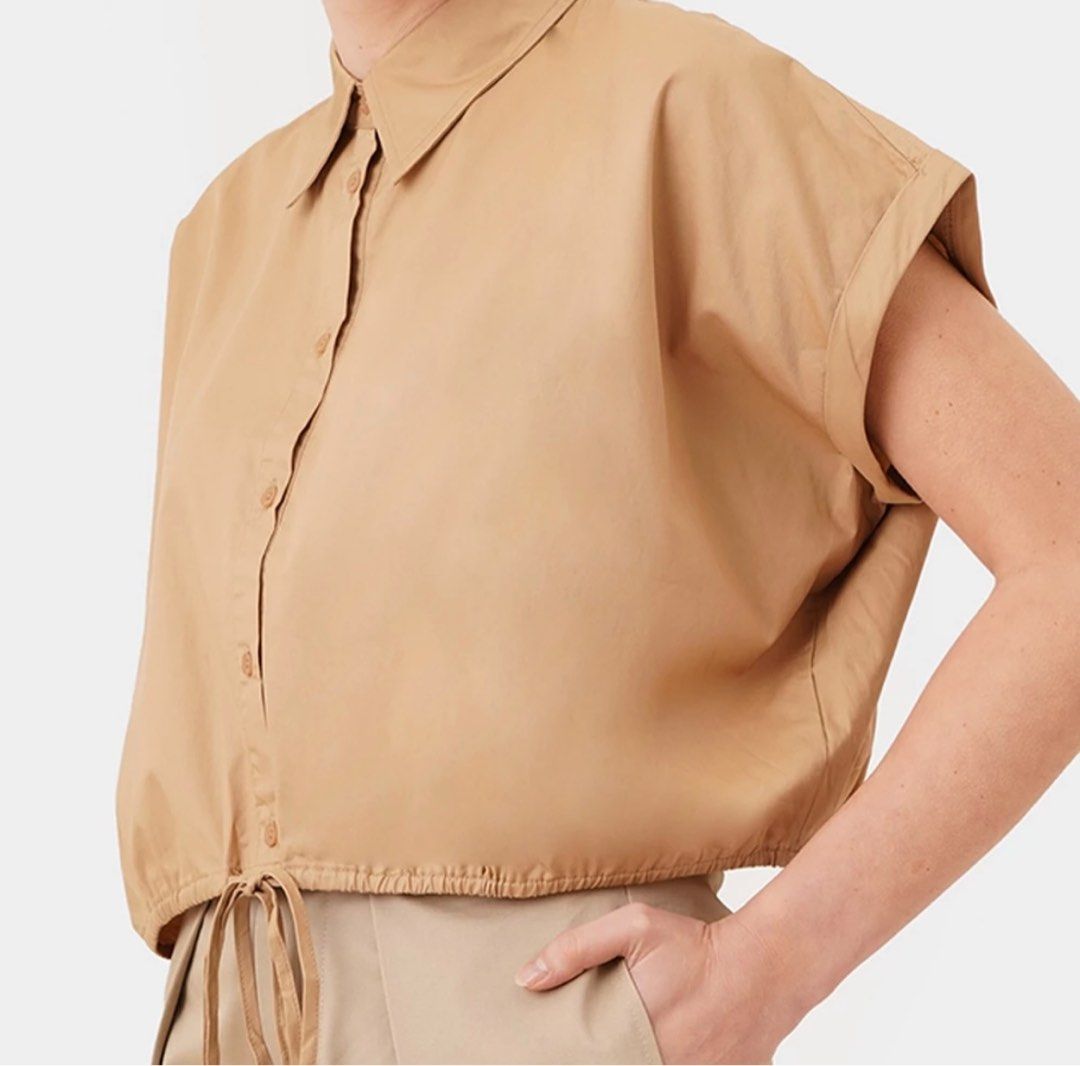 Bocu Cap Sleeve Draw Hem Cropped Shirt (Category: Blouses) located in Caloocan City. Submitted by gold_m (Listing ID 1289541022, Image 3). Description: - Fit: Boxy - Design Details: Regular Collar, Button Up, Cap Sleeves with Fixed Cuff, Shirred Back Yoke, Adjustable Self Tie Hem - Material Composition: 100% Cotton.