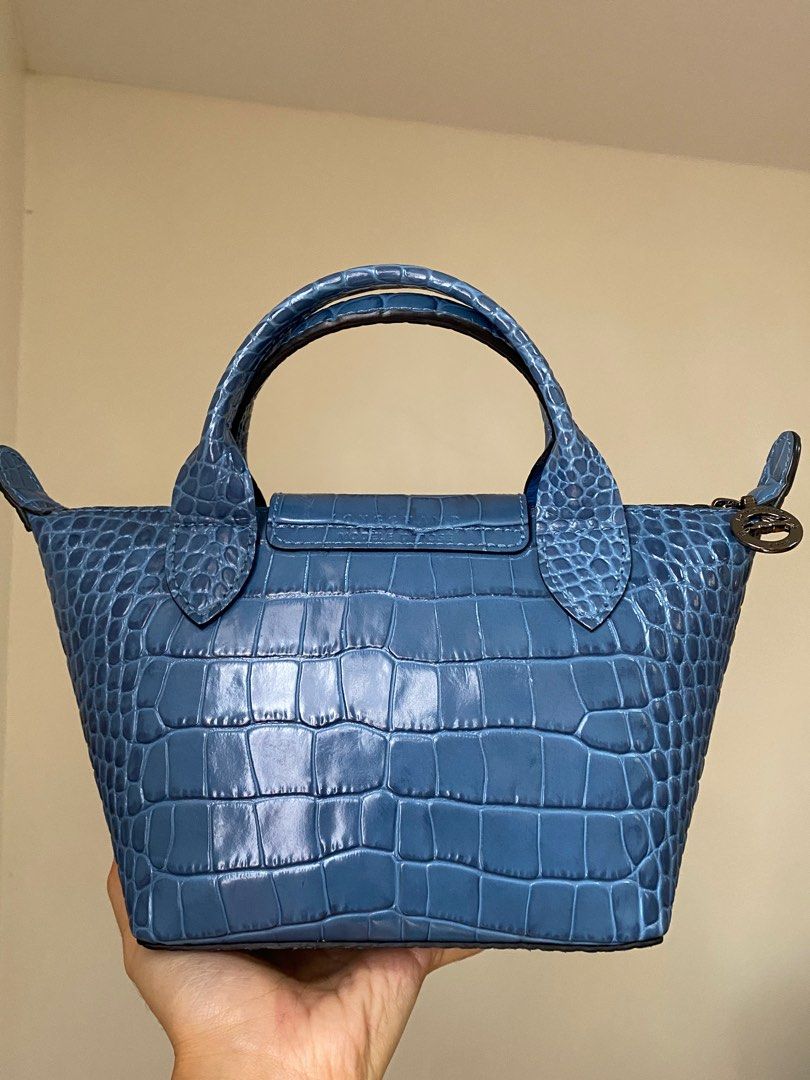Longchamp Mini Le Pliage Croc Embossed Leather (Category: Luxury Bags & Wallets) located in Pasig City. Submitted by jst.kth (Listing ID 1289474994, Image 2). Description: Longchamp Le Pliage Croc in XS From my personal collection. Used only a handful of times and it’s always stored in a dust bag. Looks and smells brand new (leather smell). It comes with a long detachable strap with the same material and color. Color is very cute and unique! RFS: