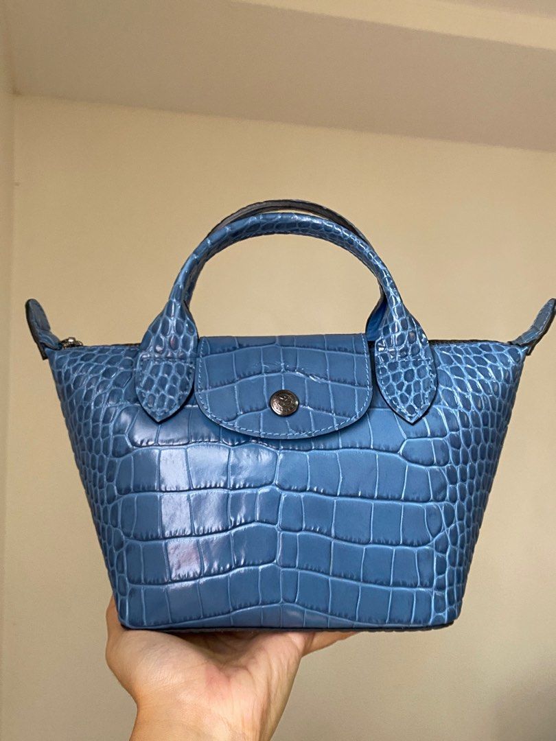 Longchamp Mini Le Pliage Croc Embossed Leather (Category: Luxury Bags & Wallets) located in Pasig City. Submitted by jst.kth (Listing ID 1289474994, Image 1). Description: Longchamp Le Pliage Croc in XS From my personal collection. Used only a handful of times and it’s always stored in a dust bag. Looks and smells brand new (leather smell). It comes with a long detachable strap with the same material and color. Color is very cute and unique! RFS: