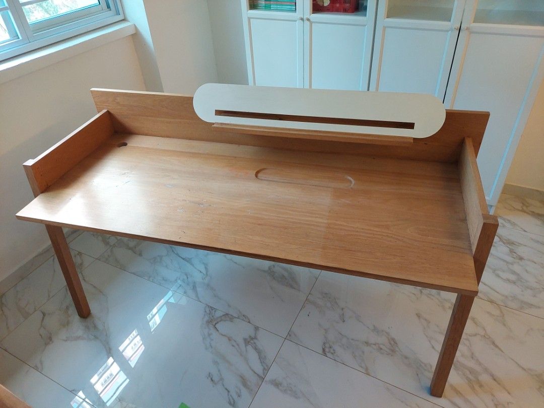 Solid wood study table (Category: Tables & Sets) located in Singapore. Submitted by tinsel (Listing ID 1289574098, Image 3). Description: Scandinavian style solid wood study desk imported from Thailand. comes with a hole drilled for cables. Very good quality. some defects on table top as in one of the pictures. please arrange your own transport as it is very heavy..