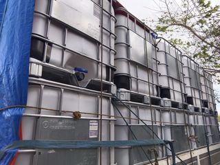 ibc tank, blue drums and containers