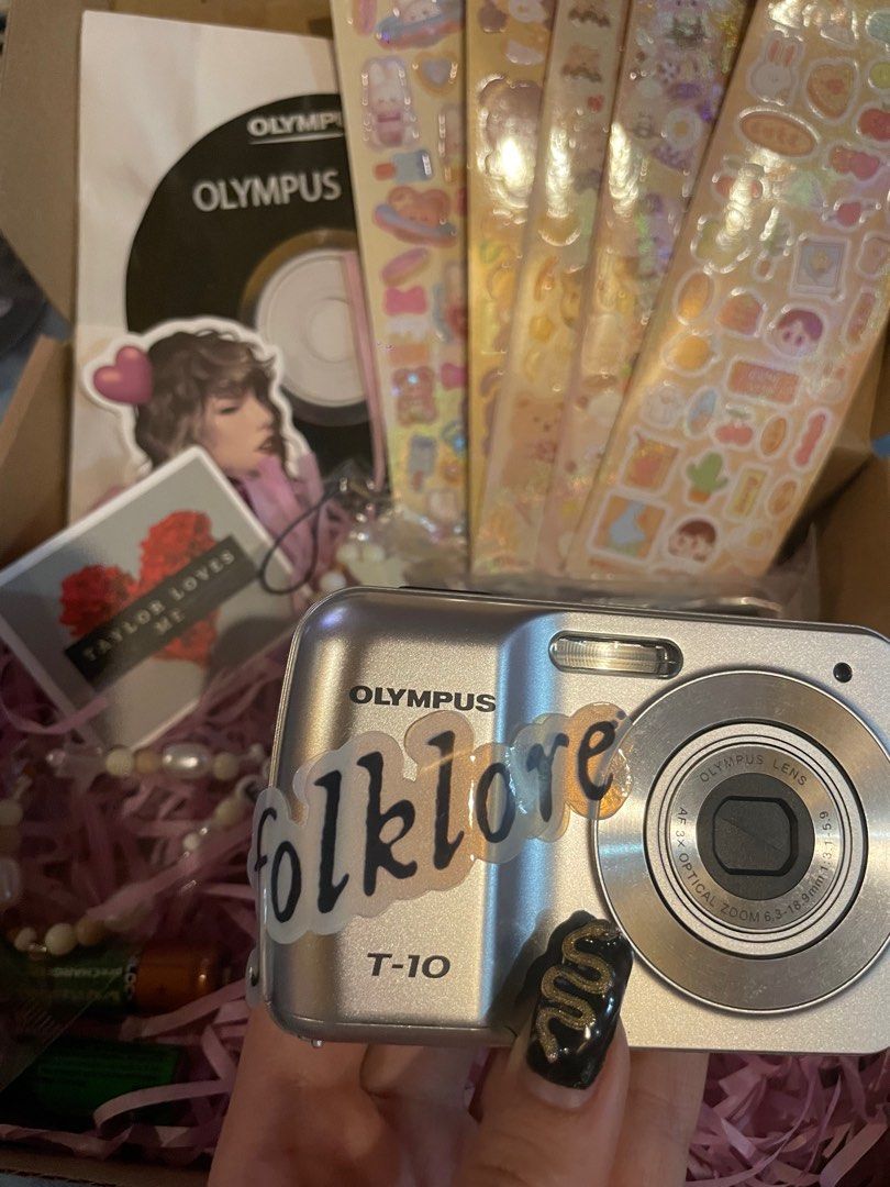 Taylor Swift Folklore Olympus T-10 Digicam Set (Category: Cameras) located in Manila. Submitted by stefandraboutique (Listing ID 1289742390, Image 3). Description: Perfect for eras tour! FOLKLORE digicam set Olympus T-10 silver 3999 php only 💕brand new 💕with new rechargeable batteries 💕ts digicam charm 💕digicam stickers 💕removable ts decal message us to order!.