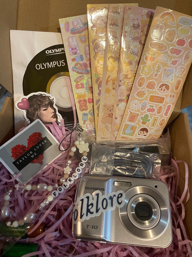 Taylor Swift Folklore Olympus T-10 Digicam Set (Category: Cameras) located in Manila. Submitted by stefandraboutique (Listing ID 1289742390, Image 2). Description: Perfect for eras tour! FOLKLORE digicam set Olympus T-10 silver 3999 php only 💕brand new 💕with new rechargeable batteries 💕ts digicam charm 💕digicam stickers 💕removable ts decal message us to order!.