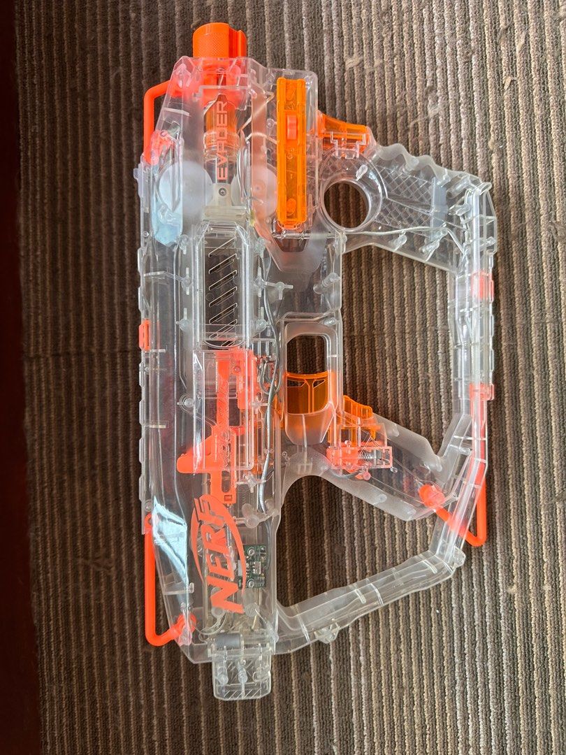 Nerf Modulus Evader (Category: Action & Battle Toys) located in Singapore. Submitted by please_buy_from_meme (Listing ID 1289965099, Image 7). Description: Great condition, rarely used Gun gun lights up when front button pressed. All original Parts included, including magazine and barrel which lights up too. Includes 12 glow in the dark waffle head darts No batteries included .