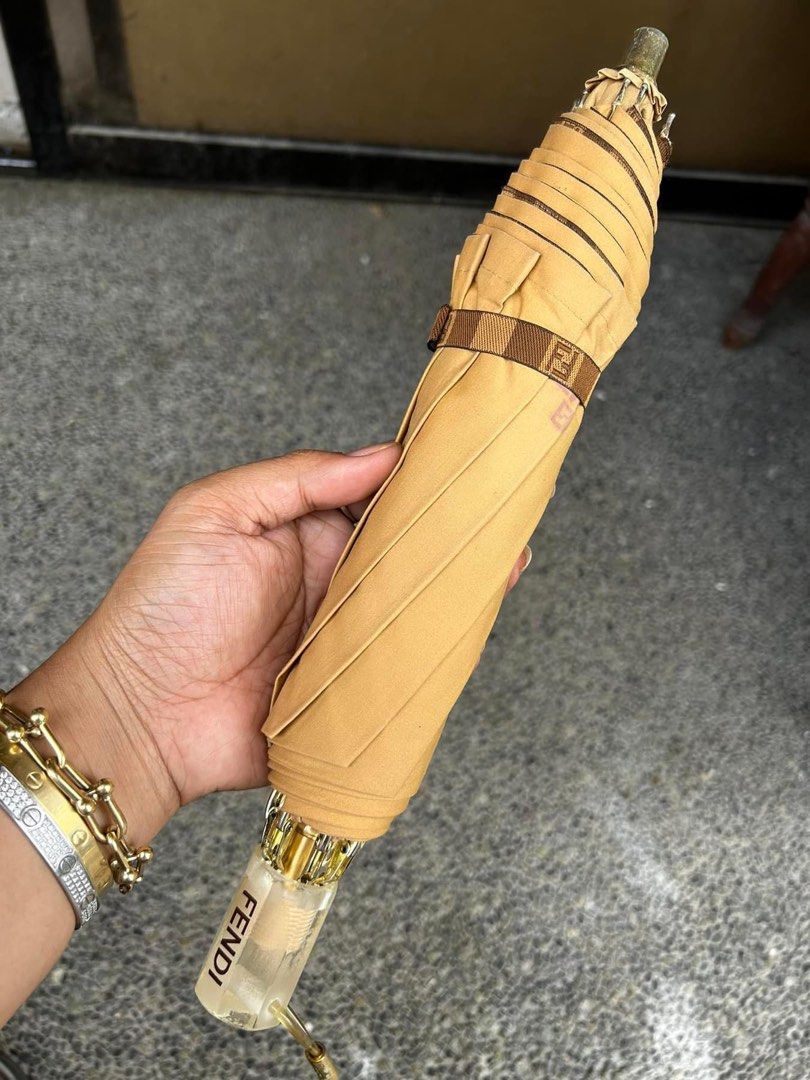 FENDI Vintage Umbrella (Category: Umbrellas) located in Quezon City. Submitted by whatsinmyclosett (Listing ID 1290341676, Image 2). Description: FENDI ORIGINAL Umbrella ☑️Item in Japan ☑️Very Good Condition ☑️manage your expectation this is second hand / Vintage Item Hindi Brand New Binibili mo! So Ganda in person Issue pay part lang ng madumi at tarnish ng harware check the photos., the umbrella is in very good condition! Fendi is fendi napaka 