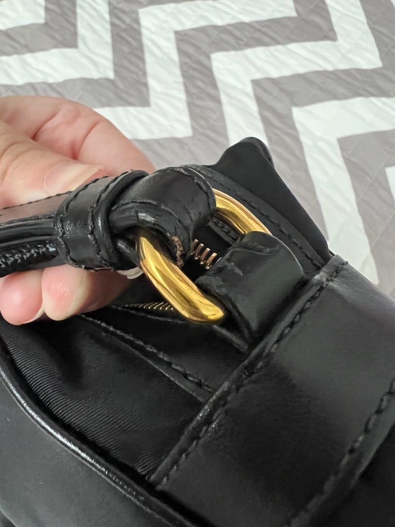 Prada Black Nylon Camera Bag (Category: Luxury Bags & Wallets) located in Binan City. Submitted by ga_closet (Listing ID 1290418754, Image 3). Description: Comes with dustbag and authenticity cards. Hard to get. Has minor cracks on the strap holder as seen on the photo. Please see photos for details. .