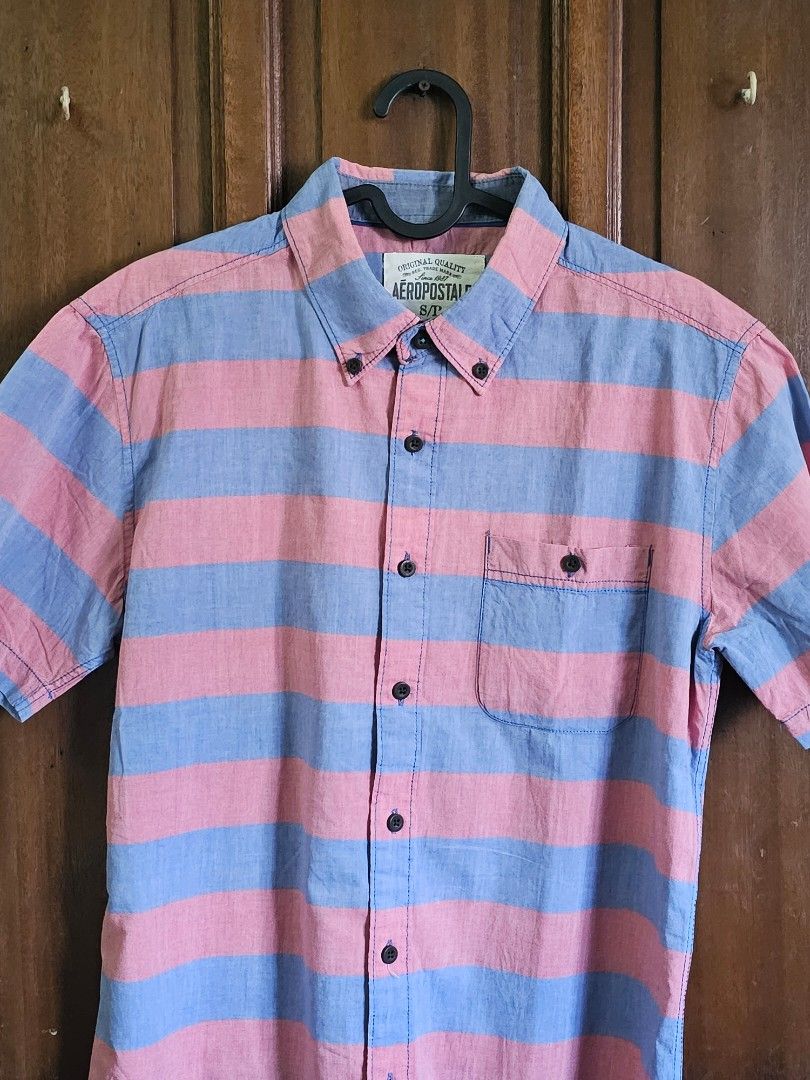 Aeropostale Stripe Shirt for Men(SMALL) (Category: Tshirts & Polo Shirts ) located in Bulacan. Submitted by reputationstore (Listing ID 1284411126, Image 3). Description: 👕Original Aeropostale stripe shirt in faded blue and faded red 👌🏻Perfect summer shirt 📏Small 🪡All buttons and extra buttons in tacked 📸Last slide: photo of me wearing it(for size reference) 💭RFS: Shirt too small now for my current body build 💸MOP GCash, UnionBank bank tr