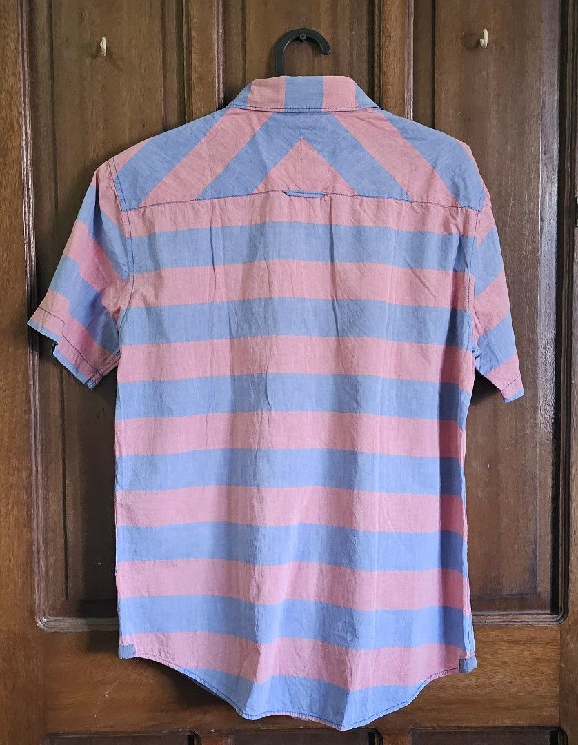 Aeropostale Stripe Shirt for Men(SMALL) (Category: Tshirts & Polo Shirts ) located in Bulacan. Submitted by reputationstore (Listing ID 1284411126, Image 2). Description: 👕Original Aeropostale stripe shirt in faded blue and faded red 👌🏻Perfect summer shirt 📏Small 🪡All buttons and extra buttons in tacked 📸Last slide: photo of me wearing it(for size reference) 💭RFS: Shirt too small now for my current body build 💸MOP GCash, UnionBank bank tr