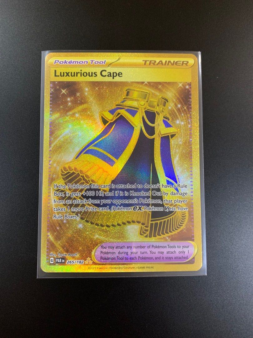 gold luxurious cape pokemon card - 265/182 - Paradox Rift - Hyper Rare - Foil If the Pokemon this card is attached to doesnt have a Rule Box Luxurious Cape 265/182 SV04: Paradox