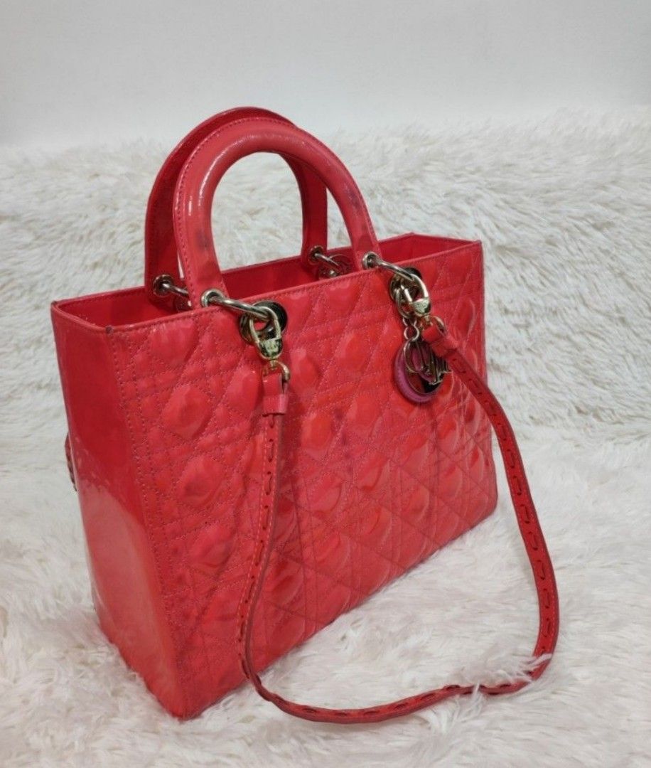 DIOR Pink Large Cannage Patent Leather Bag (Category: Luxury Bags & Wallets) located in Cavite. Submitted by yerbua103 (Listing ID 1284632865, Image 3). Description: 👛The lady Dior bag represents Christian Dior's vision of elegance and feminity. It is made with vibrant pink patent leather complimented with silver hardware. This classic style features the cannage detailing with the Dior charm. The top handle style comes with a detachable shoulder