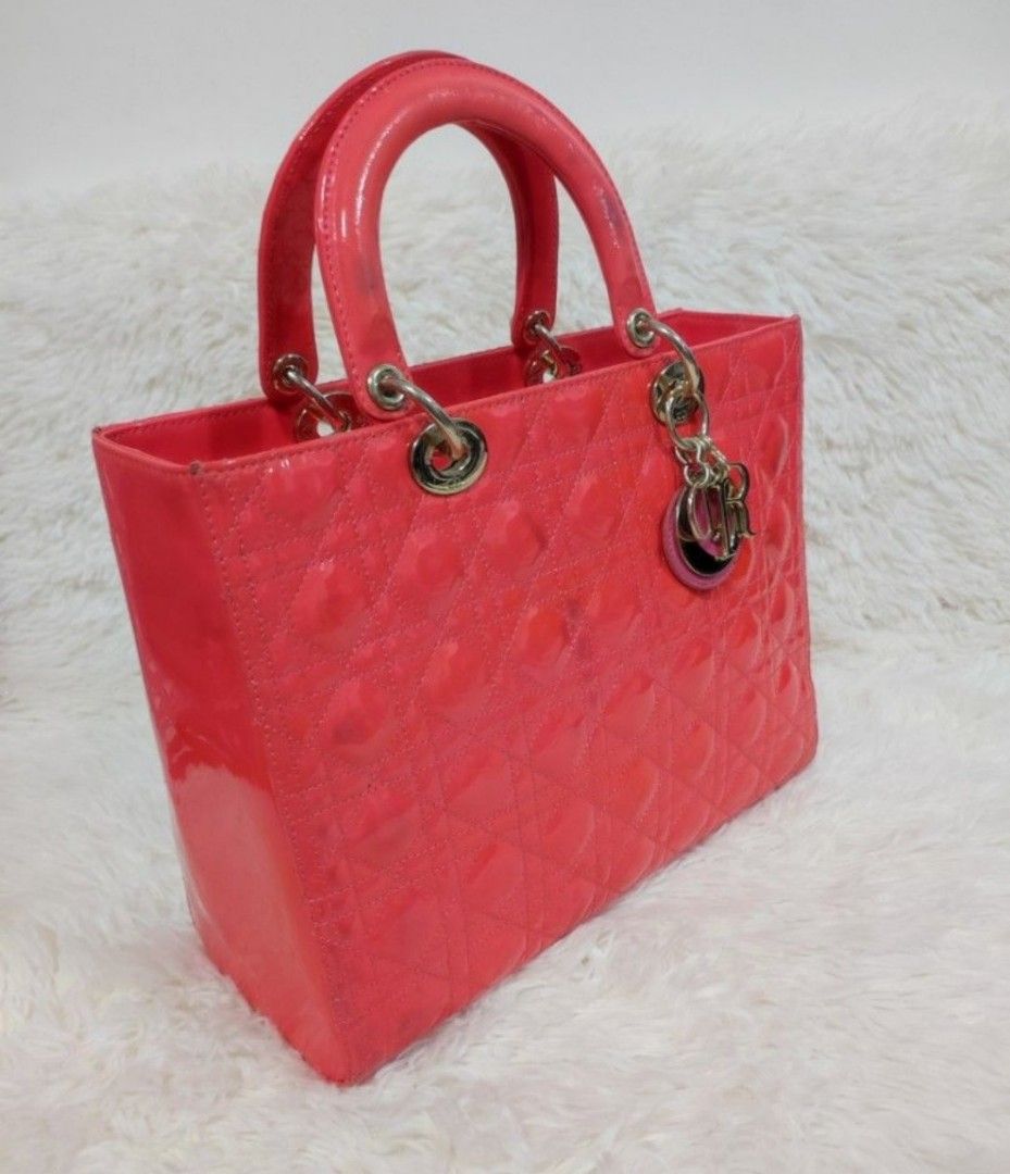 DIOR Pink Large Cannage Patent Leather Bag (Category: Luxury Bags & Wallets) located in Cavite. Submitted by yerbua103 (Listing ID 1284632865, Image 2). Description: 👛The lady Dior bag represents Christian Dior's vision of elegance and feminity. It is made with vibrant pink patent leather complimented with silver hardware. This classic style features the cannage detailing with the Dior charm. The top handle style comes with a detachable shoulder