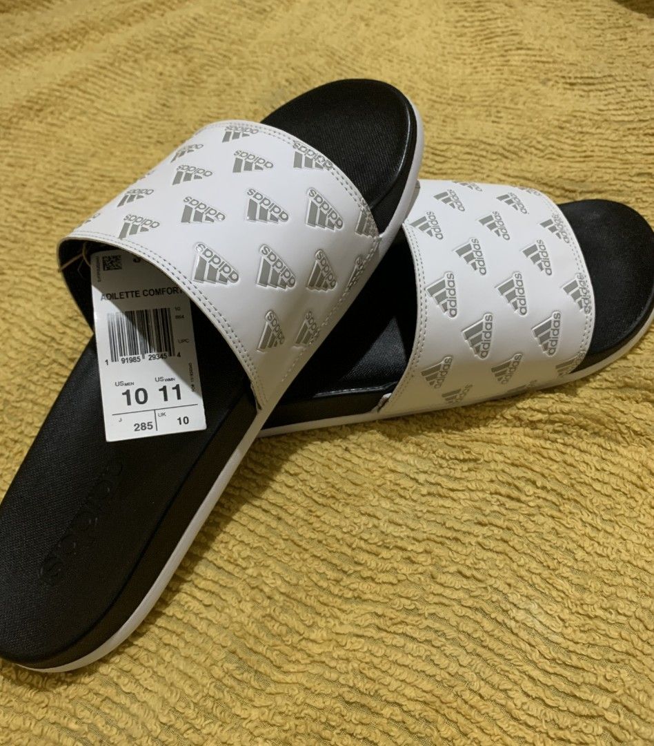 Original Adilette Comfort Slides/Cloud White (Category: Slippers and slides) located in Dasmarinas. Submitted by monching123 (Listing ID 1285049715, Image 1). Description: Original Adilette Comfort Slides/Cloud White/Grey Two/ Cloud White Size 10 GV9737 Lightweight and Contour Footbed Call Zero 907987 Three 032 Negotiable.