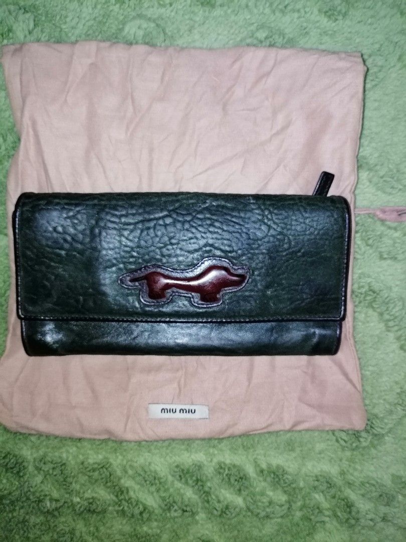 Miu miu vintage bifold wallet (Category: Luxury Bags & Wallets) located in Cabuyao City. Submitted by _disposedarmoire_ (Listing ID 1285319372, Image 1). Description: Kindly read: Miu miu wallet Pre-Owned The brand is a sister company of Prada. One of the best leather in the industry. This wallet is more than 20 years old. Never been used. It is in very good condition. Bifold 7"x3.5" 4 inner compartments 6 card slots Dark green almost black leath