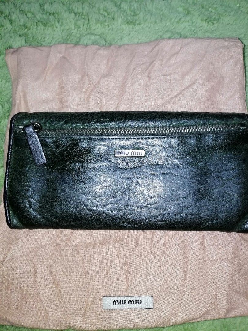 Miu miu vintage bifold wallet (Category: Luxury Bags & Wallets) located in Cabuyao City. Submitted by _disposedarmoire_ (Listing ID 1285319372, Image 3). Description: Kindly read: Miu miu wallet Pre-Owned The brand is a sister company of Prada. One of the best leather in the industry. This wallet is more than 20 years old. Never been used. It is in very good condition. Bifold 7"x3.5" 4 inner compartments 6 card slots Dark green almost black leath