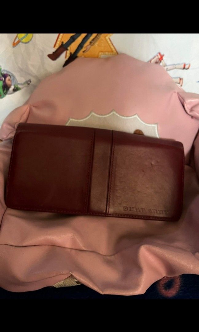 BURBERRY Clasp leather wallet (Category: Luxury Bags & Wallets) located in Quezon City. Submitted by uptrendglam (Listing ID 1285427971, Image 2). Description: Burberry long leather wallet in burgundy color with card ,bills and coins slots. Designed in a unique Burberry way. Guaranteed authentic. Issue: kindly refer to photos above RFS Decluttering.