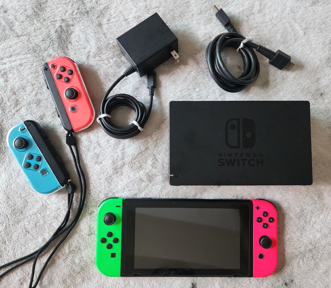 Nintendo Switch Console Version 2 Improved Battery with 2 extra Joycon Remotes and Case (Category: Nintendo) located in Taguig. Submitted by sophialikestoshop (Listing ID 1285362116, Image 1). Description: Nintendo Switch Version 2. Very minor scratches only on charging deck. Actual console in pristine and excellent working condition. screen protector from purchase. No box. Comes with: - Console - Charging Deck - Original Charger - Original HDMI 