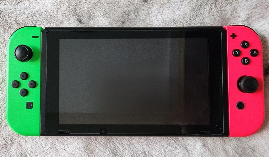 Nintendo Switch Console Version 2 Improved Battery with 2 extra Joycon Remotes and Case (Category: Nintendo) located in Taguig. Submitted by sophialikestoshop (Listing ID 1285362116, Image 3). Description: Nintendo Switch Version 2. Very minor scratches only on charging deck. Actual console in pristine and excellent working condition. screen protector from purchase. No box. Comes with: - Console - Charging Deck - Original Charger - Original HDMI 