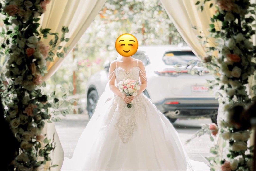 WEDDING GOWN (Fully beaded top) (Category: Evening dresses & gowns) located in Manila. Submitted by plmarn (Listing ID 1285741421, Image 2). Description: Used last December 23, 2023 *Customized wedding gown. Idea po namin ung ibang details sa design *Fully beaded ang top design. Very cameragenic * Height is 5’2 * Wearing 3 inches heels *Long trail, lakas maka princess *The color is off white. Malakas makaputi * This gown is best fit on Small to M