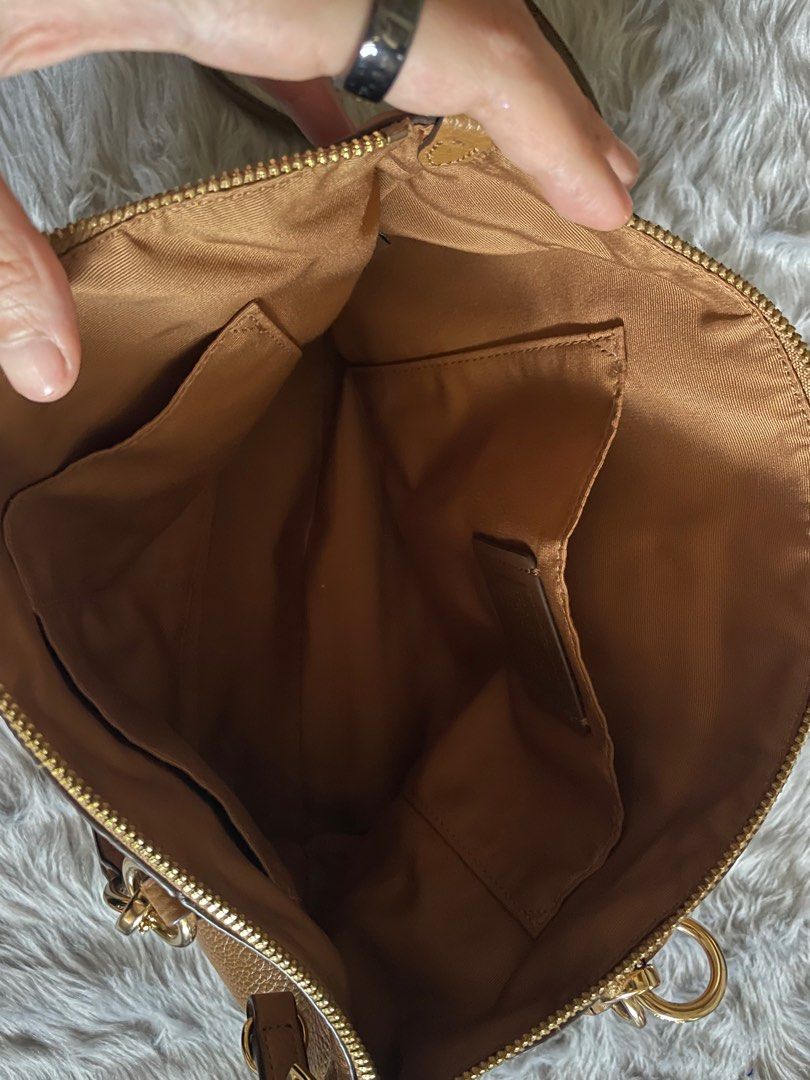 Coach Satchel Handbag (Category: Shoulder Bags) located in Taguig. Submitted by mdjpl (Listing ID 1292158369, Image 3). Description: Brown camel color Brand New, just stored with care instructions Handbag with crossbody strap RFS: Decluttering, selling low **if interested , please pay for shipping.