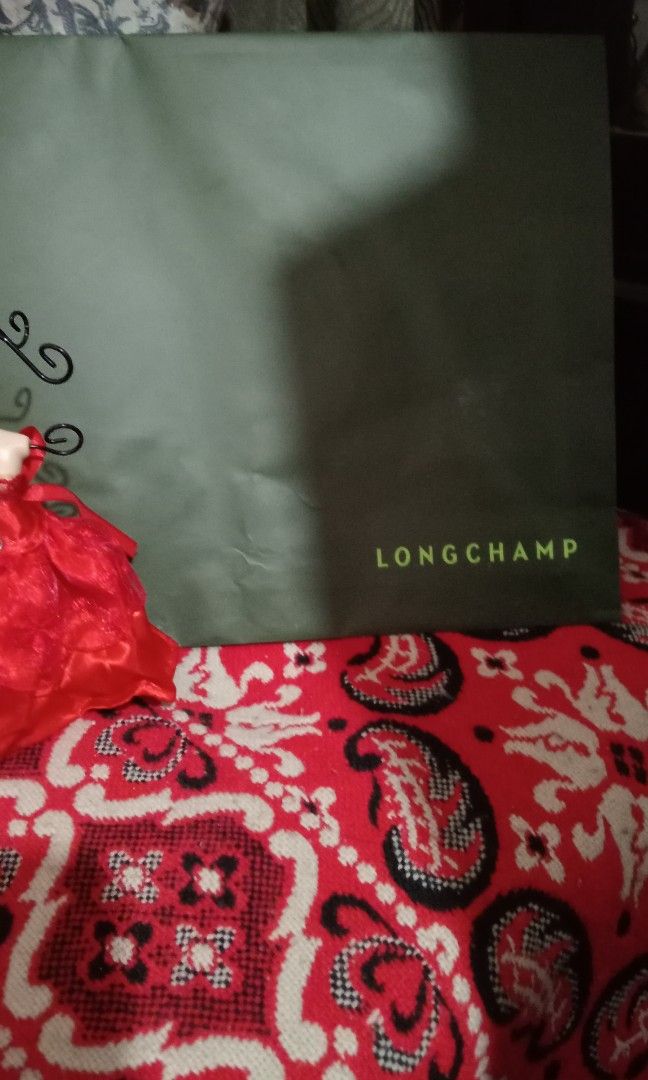 Authentic Longchamp paperbag (Category: Luxury Bags & Wallets) located in Batangas. Submitted by girlmeetspurple (Listing ID 1293231503, Image 3). Description: with paper tag and long champ embossed fabric ribbon.