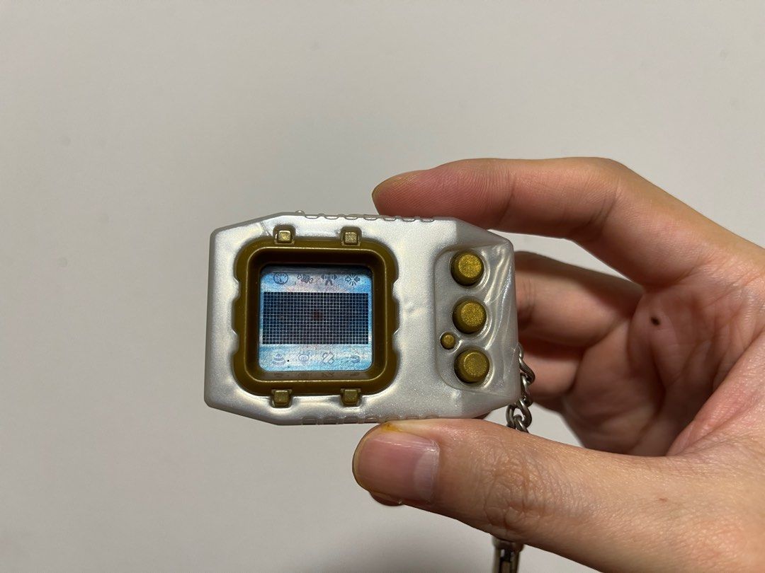 Digimon Pendulum Zero (Category: Interactive Toys) located in Singapore. Submitted by wayneteo (Listing ID 1293470346, Image 5). Description: Digimon Pendulum Zero Gold Frame. Everything working is as per photo. Sound is working. Condition close to mint. No box..