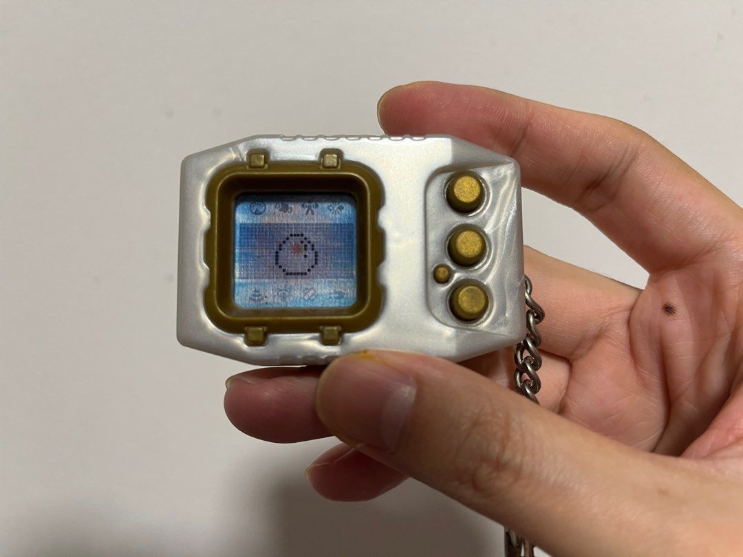 Digimon Pendulum Zero (Category: Interactive Toys) located in Singapore. Submitted by wayneteo (Listing ID 1293470346, Image 2). Description: Digimon Pendulum Zero Gold Frame. Everything working is as per photo. Sound is working. Condition close to mint. No box..