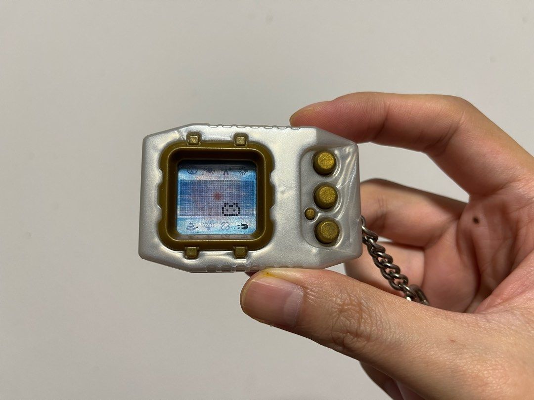 Digimon Pendulum Zero (Category: Interactive Toys) located in Singapore. Submitted by wayneteo (Listing ID 1293470346, Image 4). Description: Digimon Pendulum Zero Gold Frame. Everything working is as per photo. Sound is working. Condition close to mint. No box..