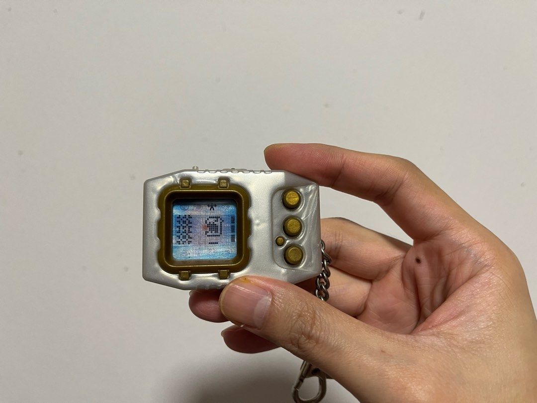 Digimon Pendulum Zero (Category: Interactive Toys) located in Singapore. Submitted by wayneteo (Listing ID 1293470346, Image 6). Description: Digimon Pendulum Zero Gold Frame. Everything working is as per photo. Sound is working. Condition close to mint. No box..