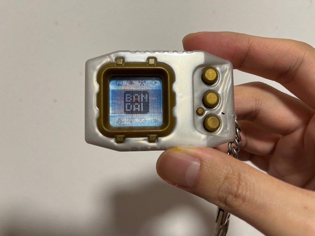 Digimon Pendulum Zero (Category: Interactive Toys) located in Singapore. Submitted by wayneteo (Listing ID 1293470346, Image 1). Description: Digimon Pendulum Zero Gold Frame. Everything working is as per photo. Sound is working. Condition close to mint. No box..