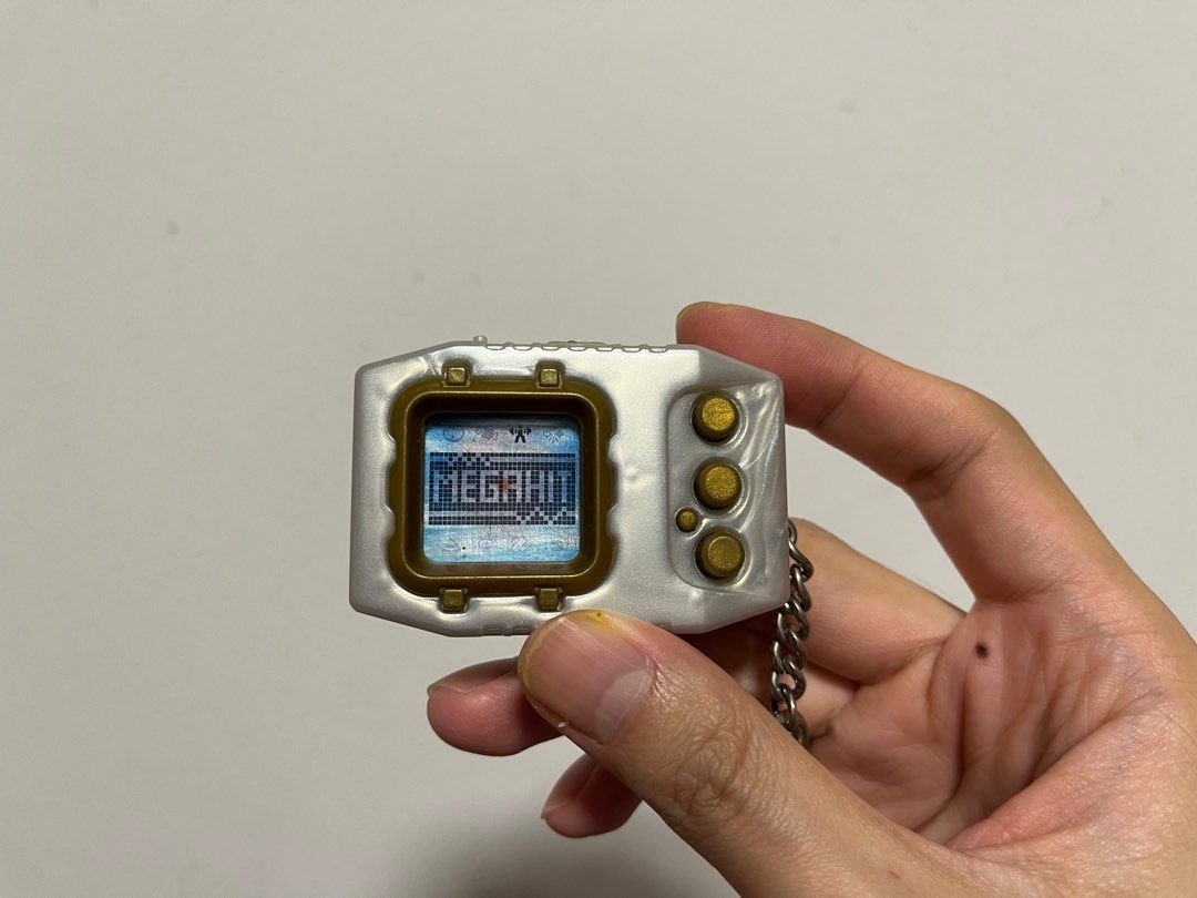 Digimon Pendulum Zero (Category: Interactive Toys) located in Singapore. Submitted by wayneteo (Listing ID 1293470346, Image 7). Description: Digimon Pendulum Zero Gold Frame. Everything working is as per photo. Sound is working. Condition close to mint. No box..
