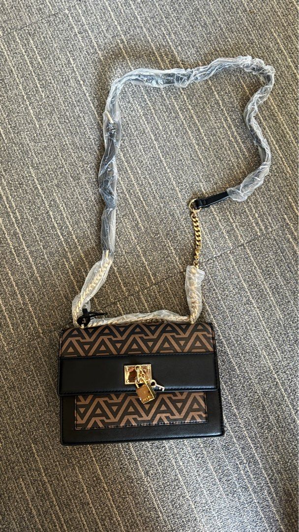 Aldo Triradia Handbag Crossbody (Category: Cross-body Bags) located in Las Pinas. Submitted by jmnb23 (Listing ID 1293768510, Image 1). Description: ORIGINAL Aldo Triradia Handbag / Crossbody - BRANDNEW, never been used - complete packaging Features: Small Crossbody Key Fob Feature Pad Lock Ornament Magnetic Snap Closure Removable Adjustable Shoulder Strap Upper: Synthetic Handle Drop Length: 10 cm Strap Drop Length: 58 cm Height: 15 cm Length: 2