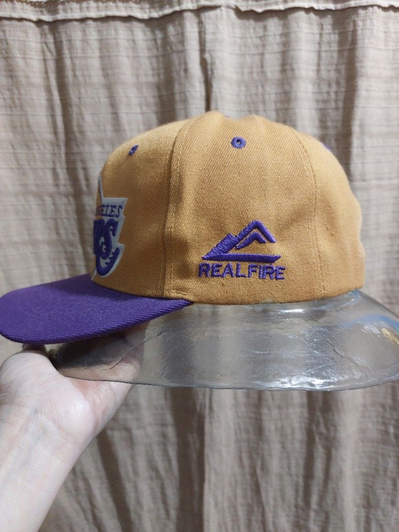 Lakers Real Fire Cap 1 (Category: Caps & Hats) located in Muntinlupa City. Submitted by sakurambo_des (Listing ID 1293806262, Image 2). Description: Los Angeles Lakers Realfire Men's Cap in very good condition.