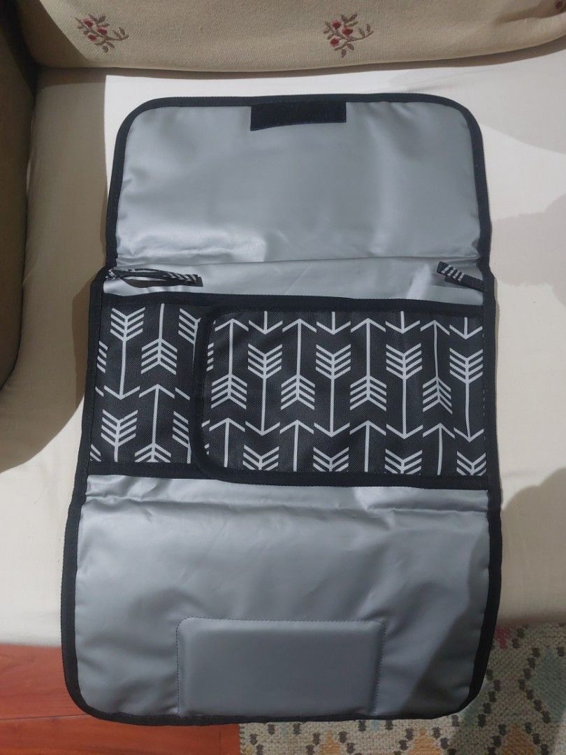 Baby portable changing pad (Category: Changing Mats & Accessories) located in Manila. Submitted by jayar29 (Listing ID 1290790524, Image 2). Description: changing pad for babies waterproof and has pockets for wet wipes etc.. reason for selling recieved two as gift...decluttering buyer pays for shipping fee.