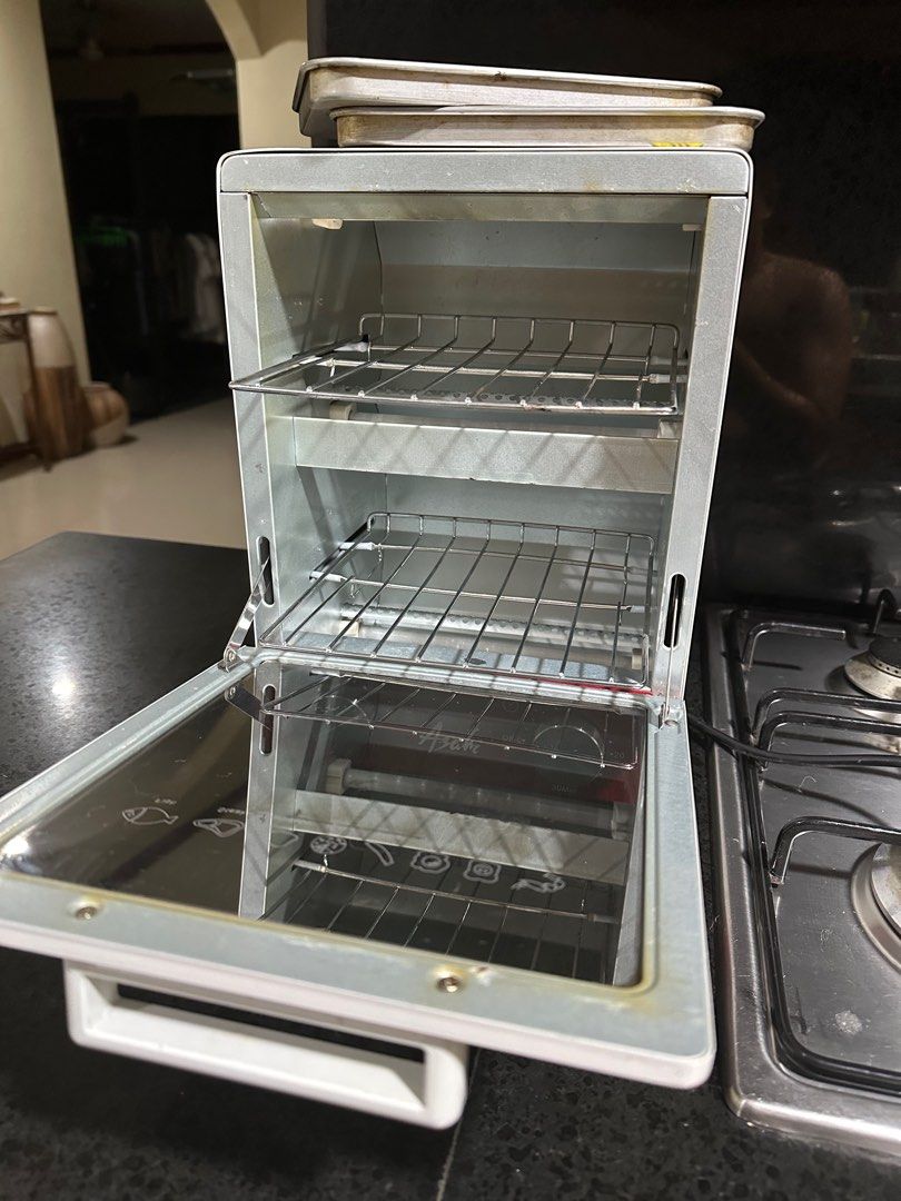 Asahi Oven Toaster (Category: Ovens & Toasters) located in San Fernando. Submitted by randomstuffphilippines (Listing ID 1294223927, Image 2). Description: 1,000W 30-minute timer with bell Thermostat controlled heating operation Powder coated steel body One way tinted glass door 3 ceramic heating tubes Double insulated AC cord 2 food trays Dimension (LxWxH): 225 x 245 x 325 mm.