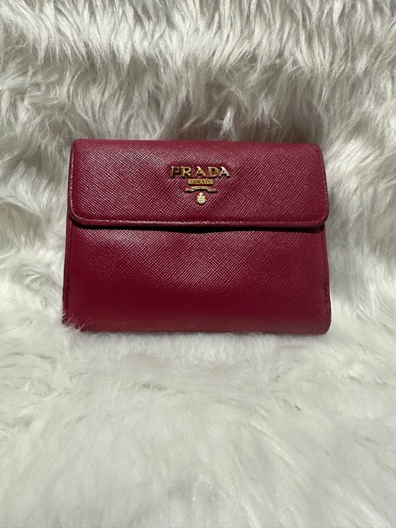 Prada compact wallet (Category: Luxury Bags & Wallets) located in Manila. Submitted by landlshopandstyle (Listing ID 1294427864, Image 1). Description: 📍actual color is fuchsia pink due to lighting its like color red but its not 📍authentic 📍pre loved.