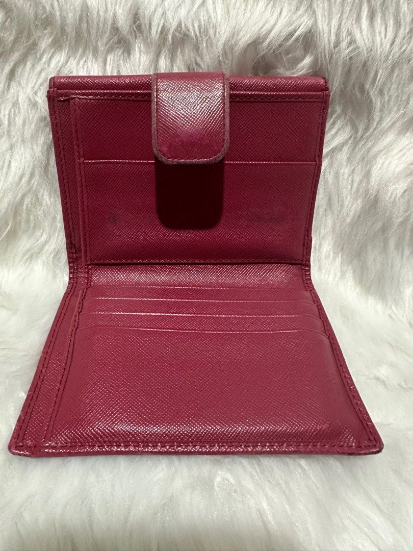 Prada compact wallet (Category: Luxury Bags & Wallets) located in Manila. Submitted by landlshopandstyle (Listing ID 1294427864, Image 3). Description: 📍actual color is fuchsia pink due to lighting its like color red but its not 📍authentic 📍pre loved.