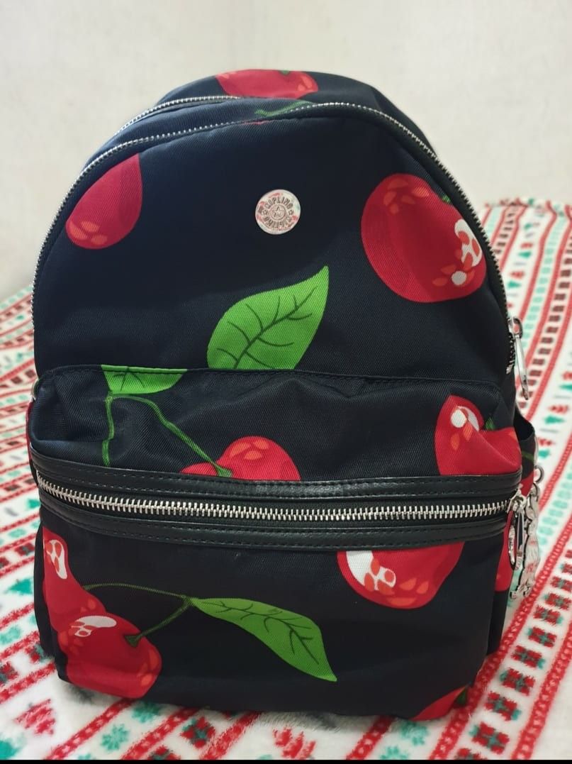 ORIGINAL Kipling Cherry Backpack (Category: Luxury Bags & Wallets) located in Marikina City. Submitted by arc_co. (Listing ID 1294457151, Image 1). Description: Women Cherry Print Back Pack 38 H x 36 L x 14 W cm Black/Red With laptop compartment Bought and stored only can pass as brand-new.