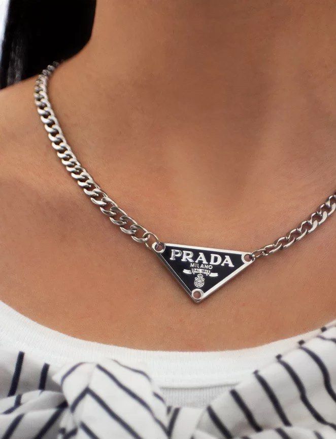 Upcycled Prada logo charm reworked into a necklace