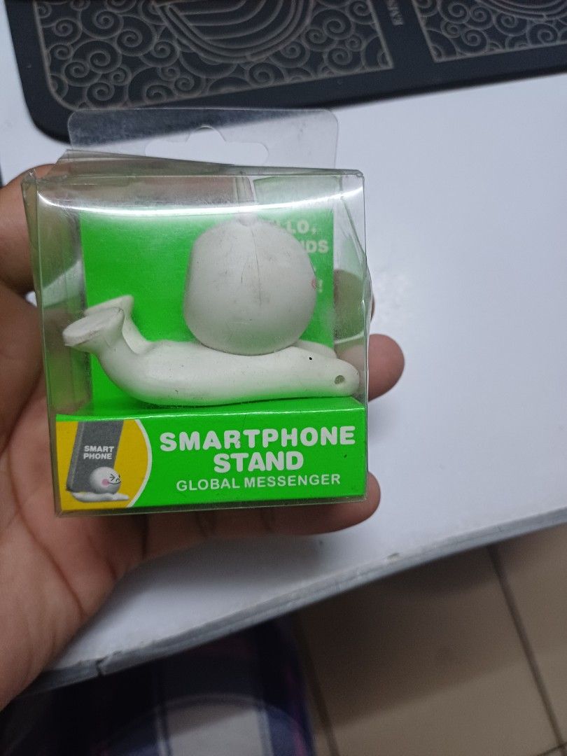 Smart phone stand (Category: Mounts & Holders) located in Manila. Submitted by chinito191983 (Listing ID 1295174531, Image 2). Description: stand for all cellphone Product Description Features 1. Cute mobile phone stand made of plastic, （The base has sandbags to increase the weight of the stand.）excellent workmanship and durable, perfect to support your mobile phone.. 2.Compatible with all models. It can be easily fixed to any smart phone and tab