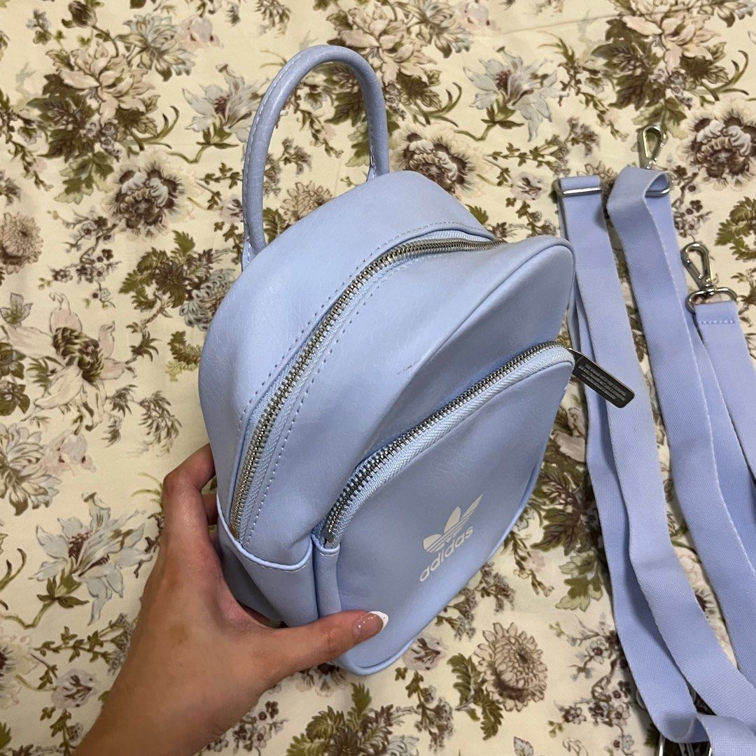 Adidas Mini Backpack in Light Blue (Category: Cross-body Bags) located in Las Pinas. Submitted by thevallerys (Listing ID 1295306263, Image 2). Description: Bought in SG for 2400 in Adidas store Can be worn as backpack, or crossbody sling! Used once only, didnt reach out for it anymore because too many bags See photos for slight discolouration on strap and some marks on the logo.
