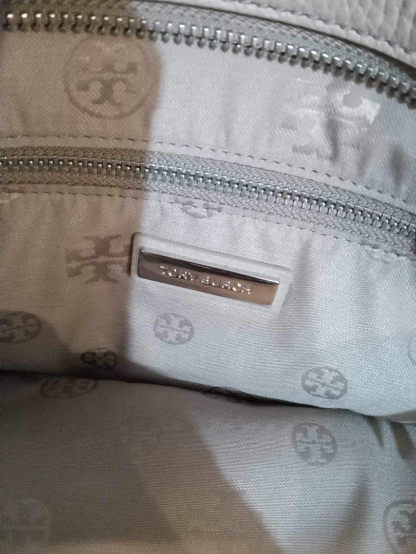 Medium Tote Tory Burch (Category: Luxury Bags & Wallets) located in Paranaque City. Submitted by lsrshop (Listing ID 1290910204, Image 3). Description: Medium Tote authentic Tory Burch Pebbled Leather Selling low - missing sling and tassels. Thea convertible tote Still Very pretty in actual. Can be used as shoulder bag or purchase own sling Color off white/ light gray Medium Tote: Top horizontal length 15 inches. Base - 11x4. Height - 9inches.