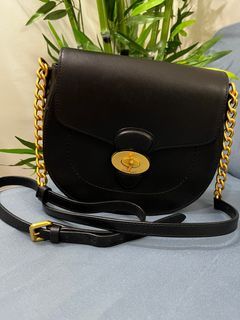 black leather saddle bag with gold hardware