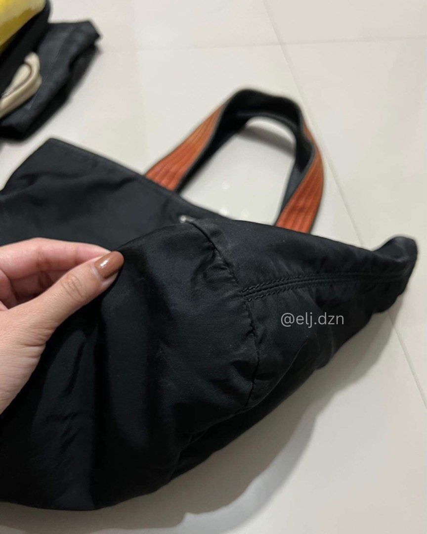 PRADA tota bag (Category: Luxury Bags & Wallets) located in Quezon City. Submitted by em.db (Listing ID 1295761279, Image 2). Description: PRADA BLACK NYLON TOTE Preloved - Authentic Also open for Authentication P13,000 only! Nego for sure buyer Quezon City 📍 No issue. Needs cleaning if maselan. Pero pwede na gamitin as is. Cash on delivery Cash on pick-up Meet up QC West Triangle / Fairview.