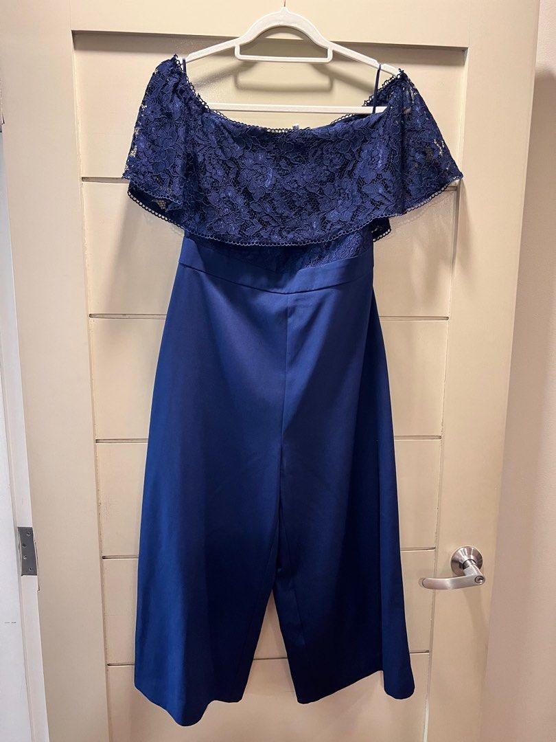 Warehouse navy blue lace romper UK12 (Category: Jumpsuits) located in Mandaluyong City. Submitted by sjo88 (Listing ID 1295766509, Image 2). Description: Warehouse navy blue lace romper / jumpsuit Excellent condition. Off-shoulder. Very elegant when worn. Rfs: too big PRICE IS FIRM.